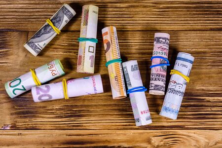 Many rolled up banknotes. Euro, american dollars, ukrainian hryvnias, egyptian pounds and russian roublesの写真素材