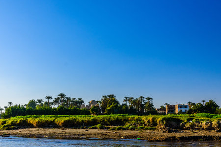 Residential buildings on a bank of Nile river in Luxor, Egyptの写真素材