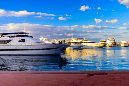White luxury yachts in sea harbor of Hurghada, Egypt. Marina with tourist boats on Red Seaの写真素材