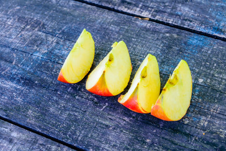 Sliced ripe apple on rustic wooden table