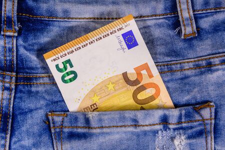 Fifty euro banknote in pocket of blue jeansの写真素材