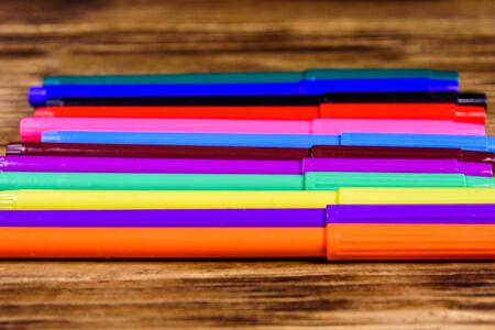 Multi colored felt tip pens on rustic wooden tableの写真素材