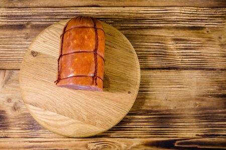Cutting board with sausage on rustic wooden table. Top viewの写真素材