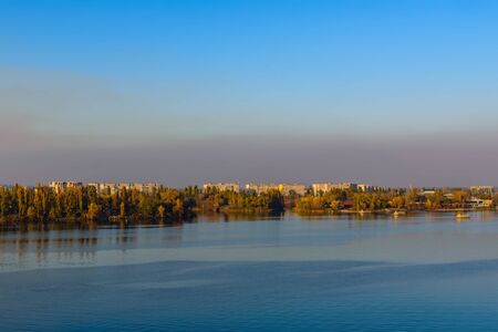 View on residential buildings of city Kremenchug and river Dnieper on autumnの写真素材