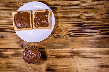 Two sandwiches with chocolate spread on white plate. Top viewの写真素材