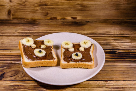 Two sandwiches with chocolate spread on plate. Sandwich like a bear muzzle