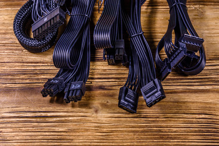 Set of computer psu cables on wooden background