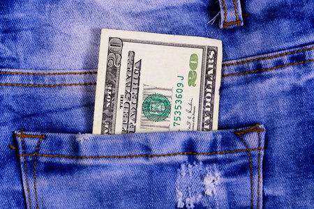American twenty dollars banknote in pocket of blue jeansの写真素材