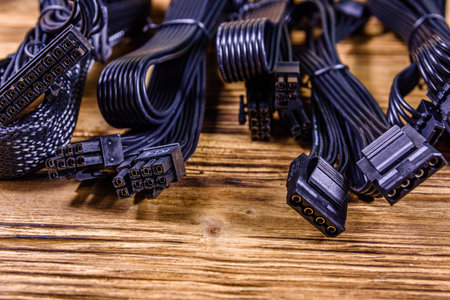Set of computer psu cables on wooden background