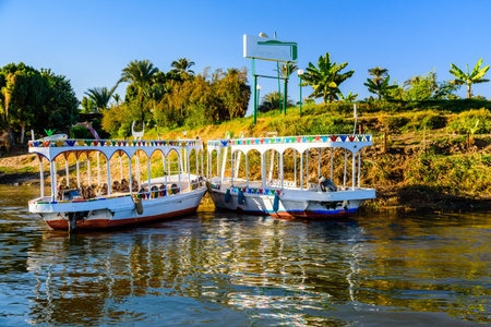 Tourist boats moored near bank of Nile river in Luxor, Egypt