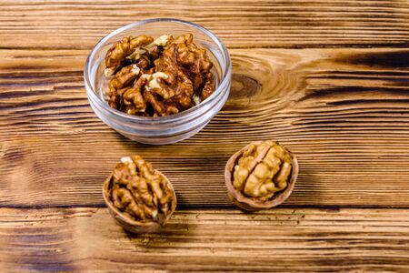 Cores of walnut in glass bowl on wooden tableの写真素材