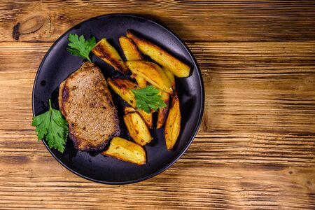 Roasted beefsteak with fried potato and parsley. Top viewの写真素材