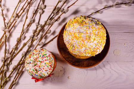 Ukrainian easter bread kulich and pussywillow branches on white wooden table