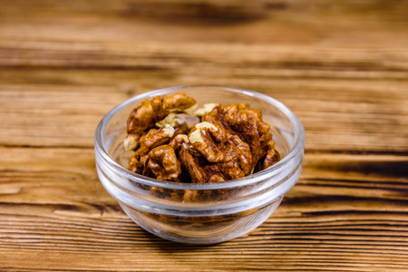 Cores of walnut in glass bowl on wooden table