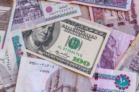American one hundred dollar banknote on heap of egyptian moneyの写真素材