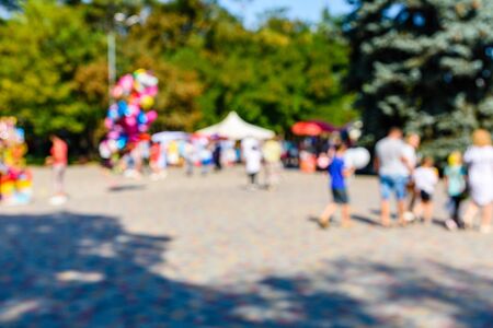 Abstract blurred background of people in city parkの写真素材