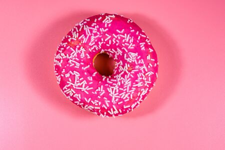Donut with glazed top isolated on pink backgroundの写真素材