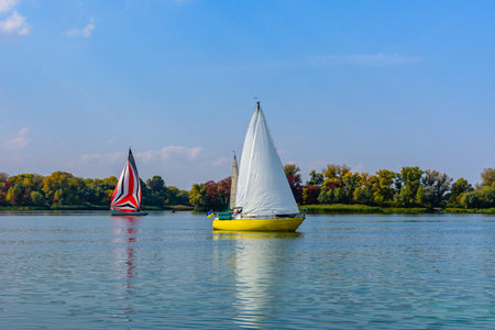Yachts at river Dnieper on autumn in Kremenchug, Ukraine. Sailing regatta