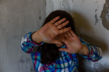 Scared young woman in abandoned house. Violence concept