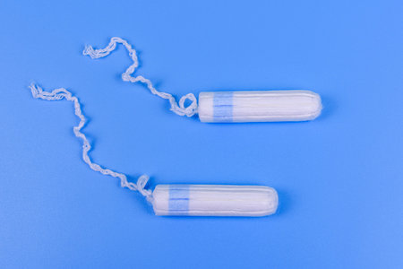 Female tampons isolated on blue background. Woman hygiene