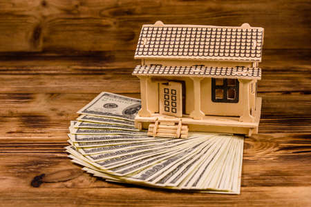Plywood model of house and one hundred dollar banknotes. Loan, real estate conceptの写真素材