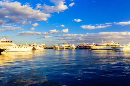 White luxury yachts in sea harbor of Hurghada, Egypt. Marina with tourist boats on Red Sea