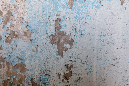 Background of the old wall in abandoned apartment. Old paint cracked