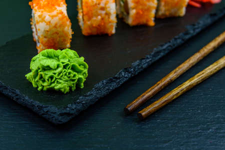 Sushi roll philadelphia with salmon, rice, cheese, cucumber, avocado and caviar on slate board. Japanese foodの写真素材