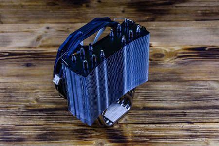 Modern cpu cooler with heat pipes on wooden backgroundの写真素材