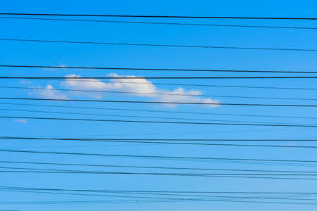 High voltage power line wires against skyの写真素材