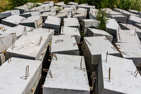 Stacks of the new concrete curbs near roadside