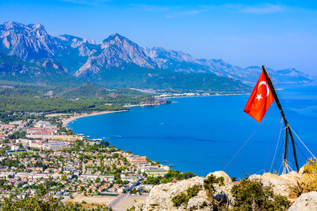 Aerial view of Kemer town. Antalya province, Turkey. Turkish flag on foreground