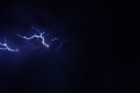 Lightning in night sky during the thunderstorm
