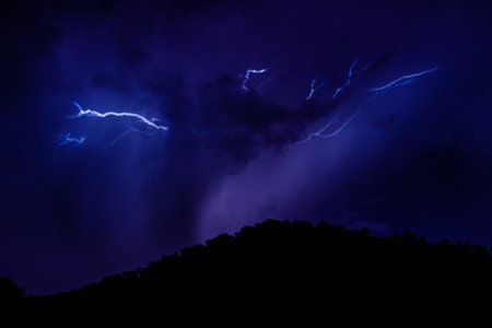 Lightning in night sky during the thunderstorm
