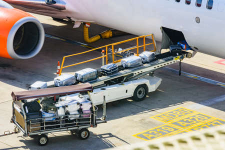 Loading luggage in airplane at airport in Antalya city, Turkeyの写真素材