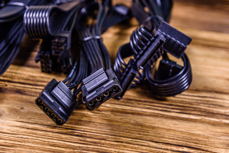 Set of computer psu cables on wooden background