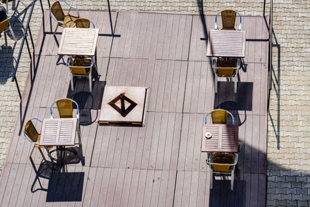 Chairs and tables in cozy street cafe. Top view