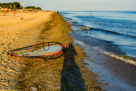 Windsurfing sail on a sand at sea shoreの写真素材