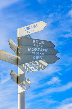 White metal signpost with names of capital cities at summit of Tahtali mountain. Kemer, Turkeyの写真素材