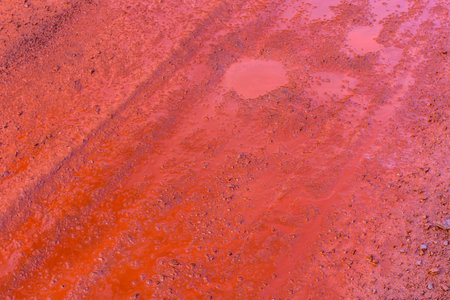 Background of red dirt road polluted with iron ore. Environmental pollutionの写真素材