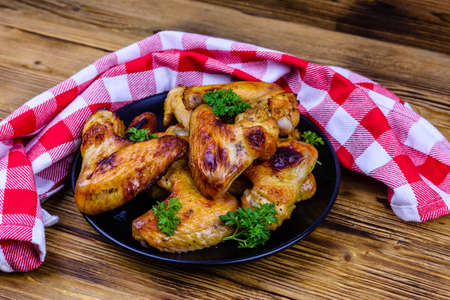 Pile of roasted chicken wings on plateの写真素材