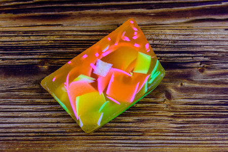 Piece of handmade soap on wooden background. Top view