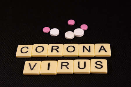 Antibiotic pills on black background. Healthcare and medicine concept. virus inscriptionの写真素材