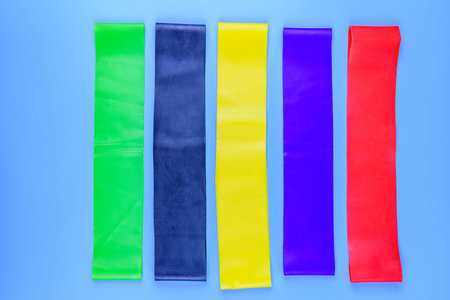Rubber fitness bands isolated on blue background