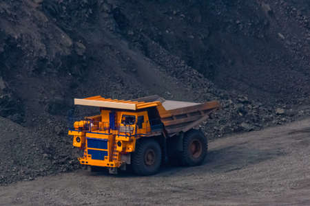Huge empty dump truck on gravel road in iron ore quarryの写真素材