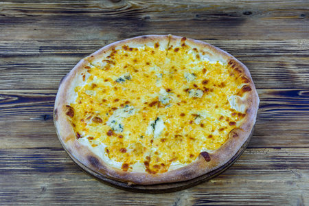 Pizza quattro formaggi (four cheeses) on wooden backgroundの写真素材