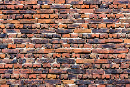 Old wall made of red bricks for background