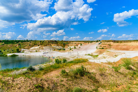 View on a lake in abandoned sand quarry and dramatic skyの写真素材
