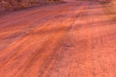 Red dirt road polluted with iron ore. Environmental pollutionの写真素材