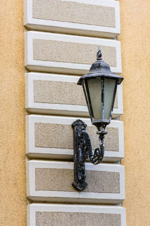 Old street light on a wall of houseの写真素材